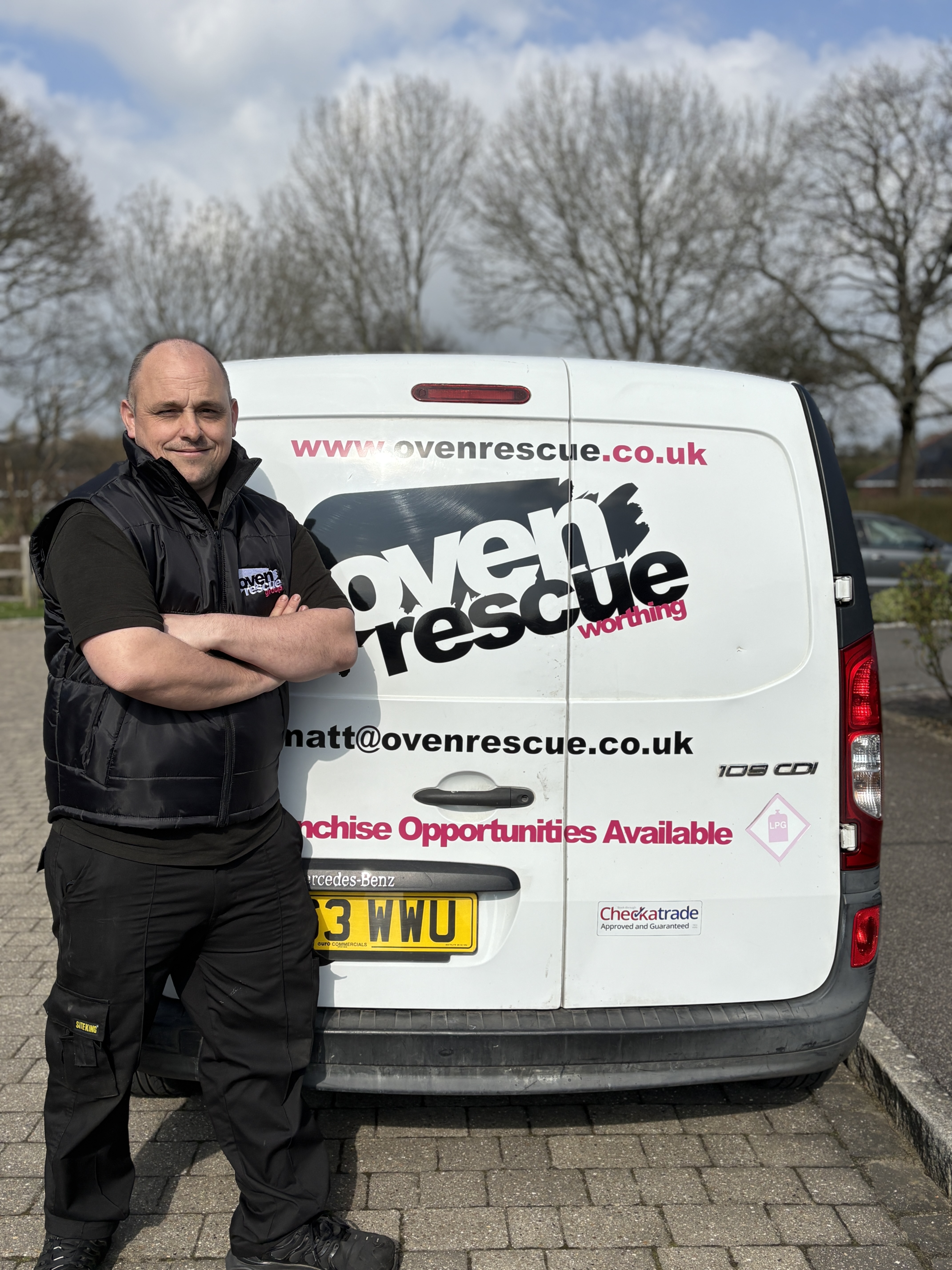 Matt Measor, Owner of Oven Rescue Worthing, smiling in front of an Oven Rescue van.