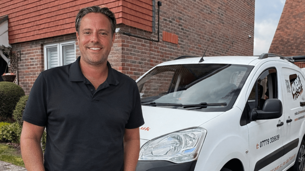 Brett Kempe, owner of Oven Rescue Croydon smiling in front of van