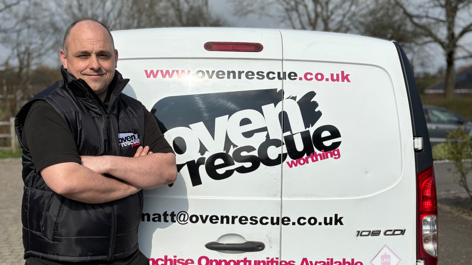 Smiling Oven Rescue Franchise owner stood in front of Oven Rescue Van