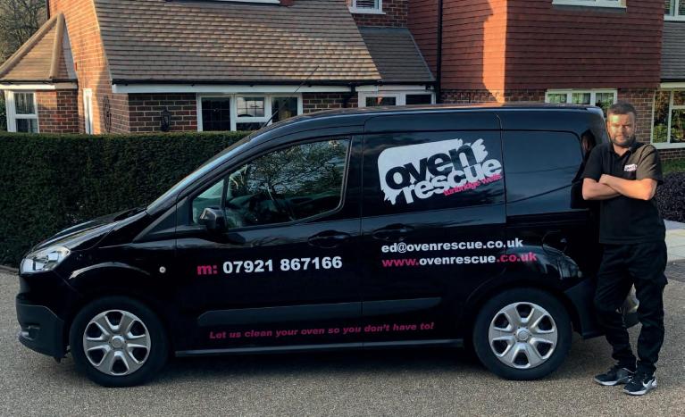 Man smiling in front of Oven Rescue van