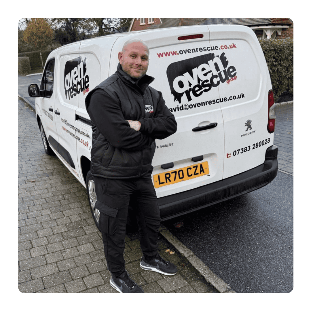 bald man smiling in front of oven rescue van